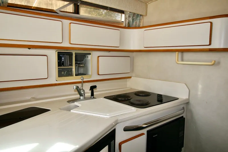 Slide: The Image of Interior of 1993 Sea Ray 370 Sundancer yacht kitchen with stove and sink. - 17