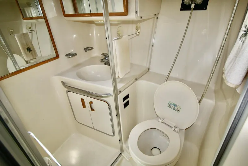 Slide: The Image of Bathroom interior of 1993 Sea Ray 370 Sundancer yacht, featuring sink and toilet. - 21