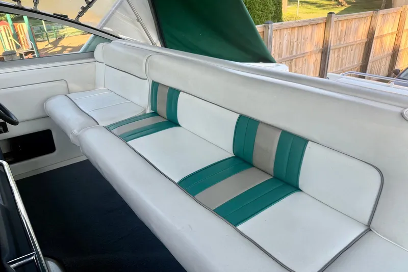 Slide: The Image of Interior seating of 1993 Sea Ray 370 Sundancer with white and teal upholstery. - 3