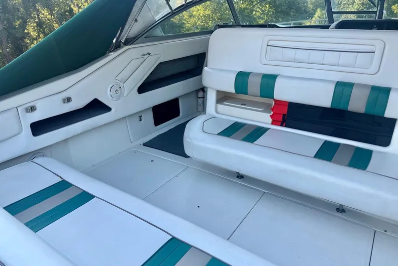 Slide: The Image of Interior of 1993 Sea Ray 370 Sundancer boat with white and teal seating. - 6