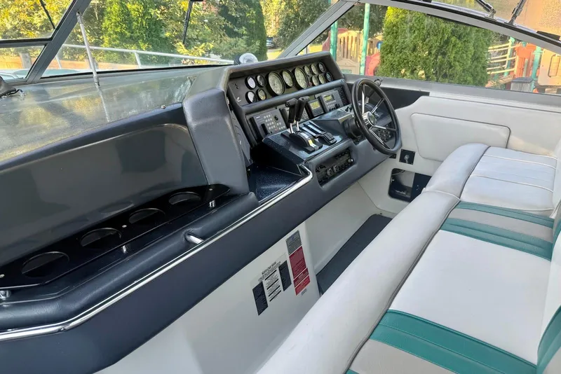 Slide: The Image of 1993 Sea Ray 370 Sundancer helm with steering wheel, gauges, and seating. - 7