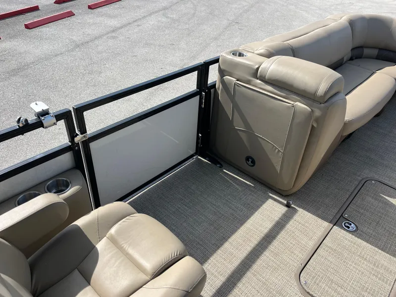 Slide: The Image of 2019 Regency 230 LE3 boat interior with beige seating and cup holders. - 11