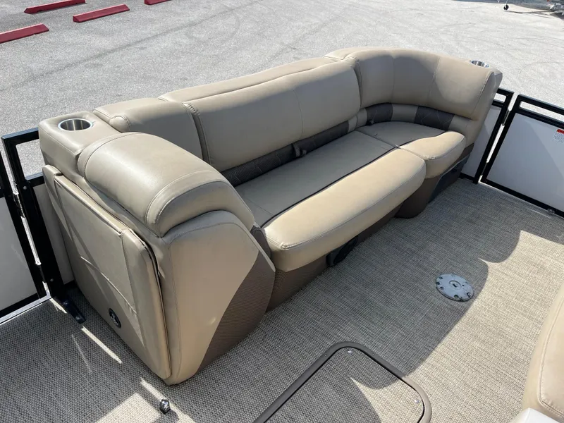 Slide: The Image of Beige seating on 2019 Regency 230 LE3 boat, featuring cup holders and carpeted flooring. - 14