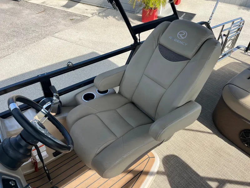 Slide: The Image of Captain's chair and steering wheel on 2019 Regency 230 LE3 boat. - 16