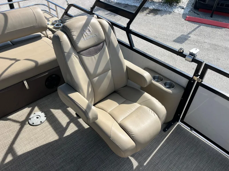 Slide: The Image of Luxurious beige captain's chair on 2019 Regency 230 LE3 boat, featuring cup holders. - 17