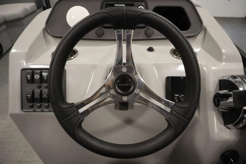 Slide: The Image of Steering wheel of 2025 Bentley Pontoons 223 Bolt Tri-Toon, featuring sleek design and controls. - 15