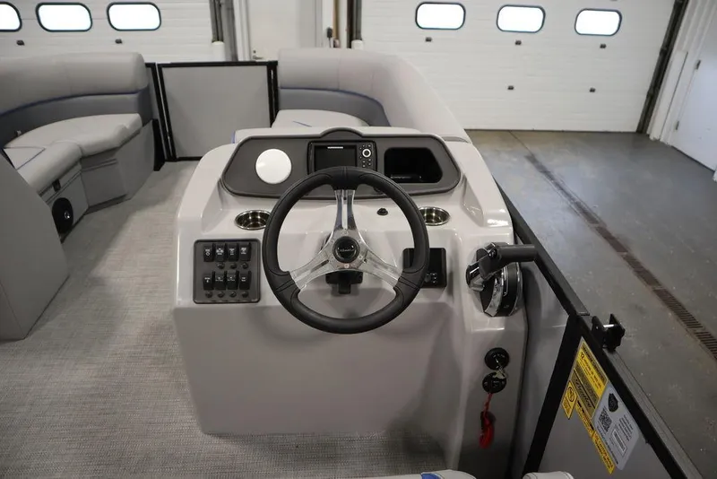 Slide: The Image of 2025 Bentley Pontoons 223 Bolt Tri-Toon interior with steering console and seating. - 17