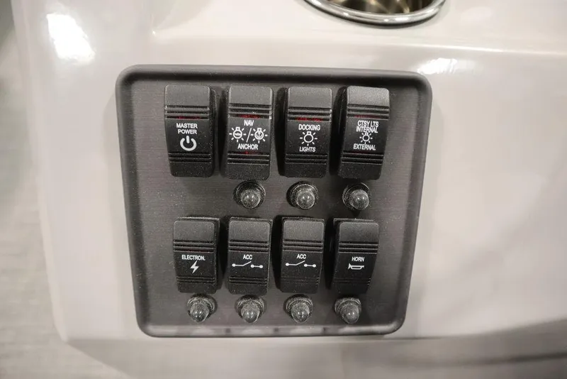 Slide: The Image of Control panel of 2025 Bentley Pontoons 223 Bolt Tri-Toon with various switches. - 22