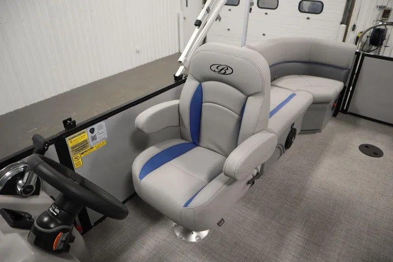 Slide: The Image of 2025 Bentley Pontoons 223 Bolt Tri-Toon interior with plush seating and steering wheel. - 25