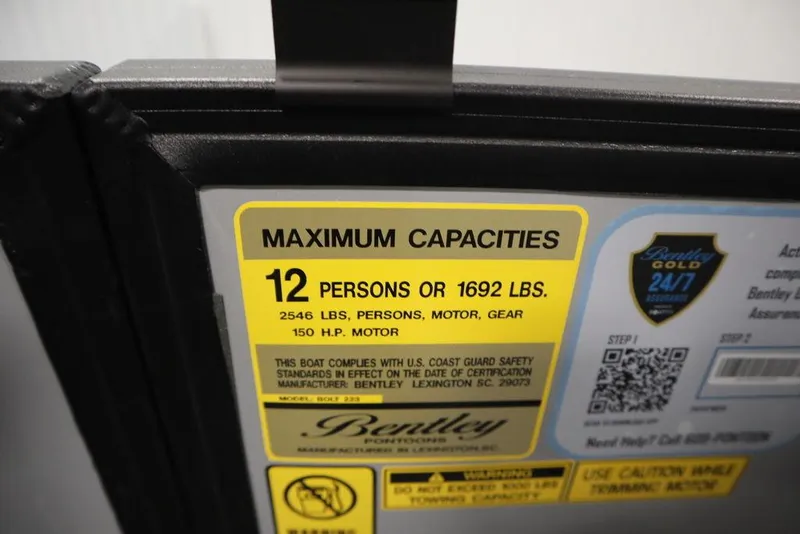 Slide: The Image of 2025 Bentley Pontoons 223 Bolt Tri-Toon capacity label, max 12 persons or 1692 lbs. - 26