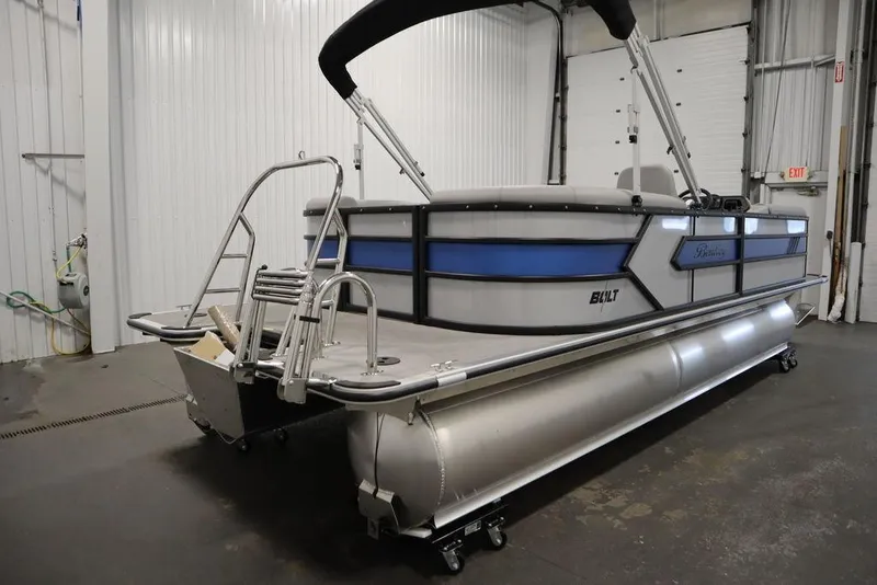 Slide: The Image of 2025 Bentley Pontoons 223 Bolt Tri-Toon in a garage, showcasing sleek design and modern features. - 3