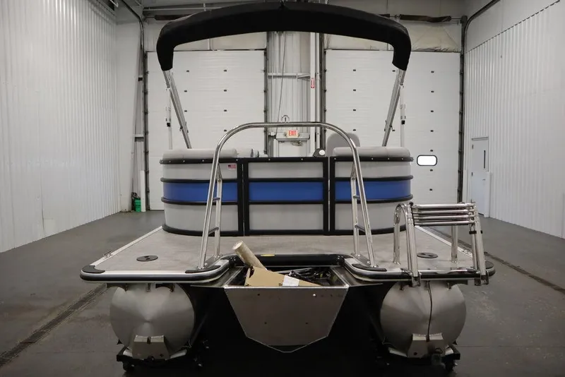 Slide: The Image of 2025 Bentley Pontoons 223 Bolt Tri-Toon in a warehouse, rear view. - 5