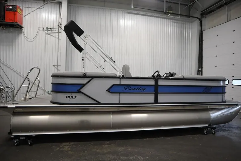 Slide: The Image of 2025 Bentley Pontoons 223 Bolt Tri-Toon in a showroom, side view. - 6