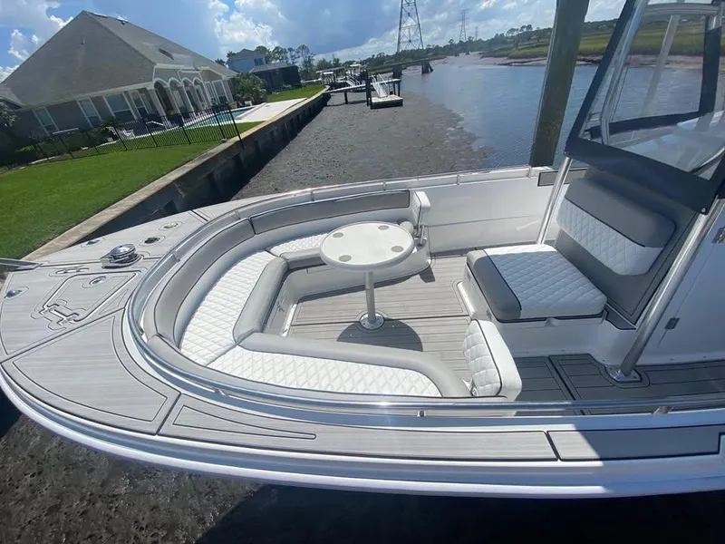 Slide: The Image of Luxurious 2025 Custom Shark Fin R321 boat with elegant seating and table on a sunny day. - 3