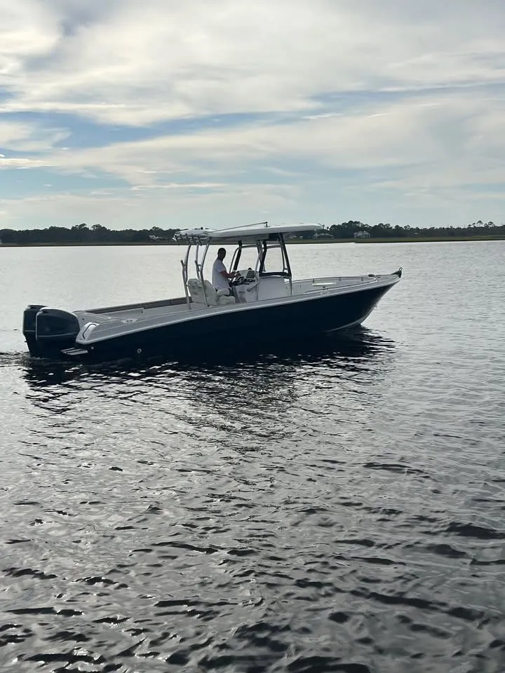 Slide: The Image of Custom Shark Fin R321 boat cruising on calm waters, 2025 model. - 4