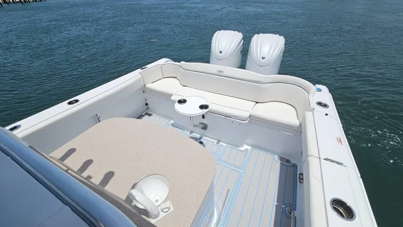 Slide: The Image of 2023 Sea Hunt Ultra 305 SE boat interior with seating and twin engines on water. - 10