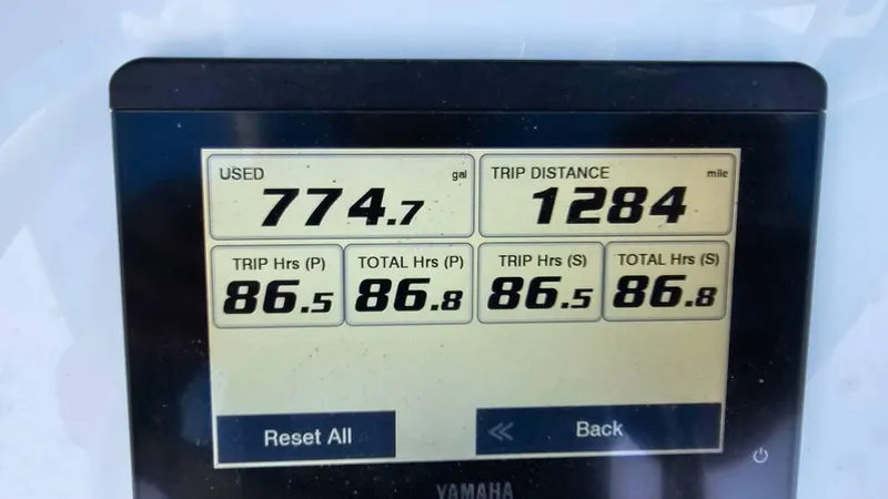 Slide: The Image of Display screen showing fuel usage, trip distance, and engine hours for 2023 Sea Hunt Ultra 305 SE. - 12