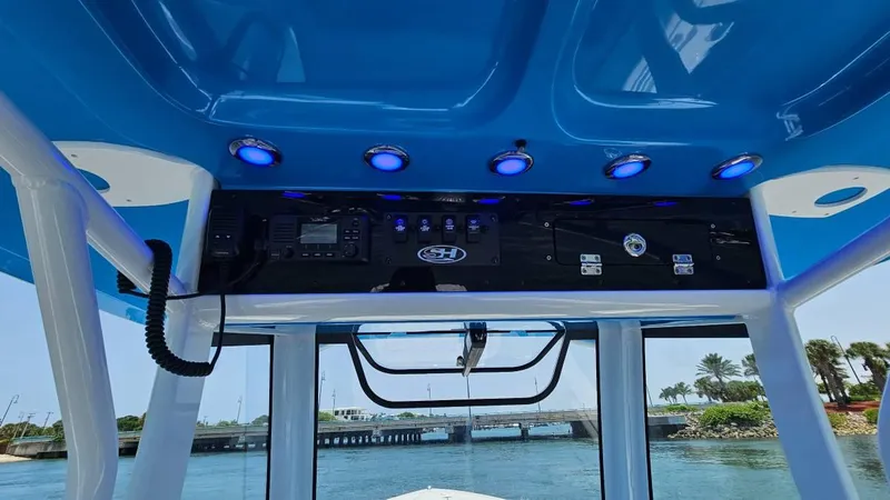 Slide: The Image of 2023 Sea Hunt Ultra 305 SE boat console with blue LED lights and navigation equipment. - 14