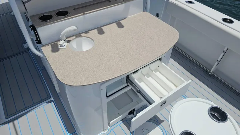 Slide: The Image of 2023 Sea Hunt Ultra 305 SE boat with open storage drawer and sink on deck. - 15