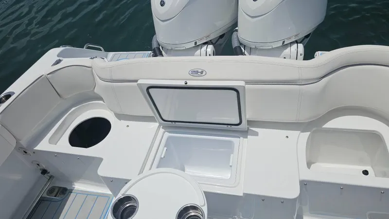 Slide: The Image of 2023 Sea Hunt Ultra 305 SE boat interior with open storage and twin engines. - 20