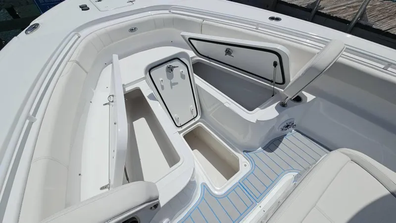Slide: The Image of 2023 Sea Hunt Ultra 305 SE boat interior with open storage compartments. - 22