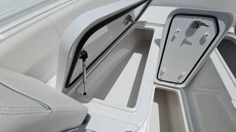 Slide: The Image of 2023 Sea Hunt Ultra 305 SE boat storage compartments with open hatches. - 23