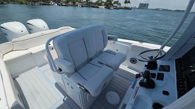 Slide: The Image of 2023 Sea Hunt Ultra 305 SE boat interior with dual engines, helm, and seating. - 8