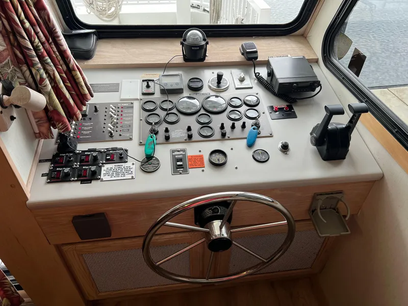 Slide: The Image of Control panel of a 1996 Fun Country 56 Forever 10 House Boat with steering wheel and gauges. - 13