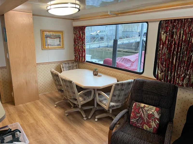 Slide: The Image of Interior of 1996 Fun Country houseboat with dining area and large window view. - 14