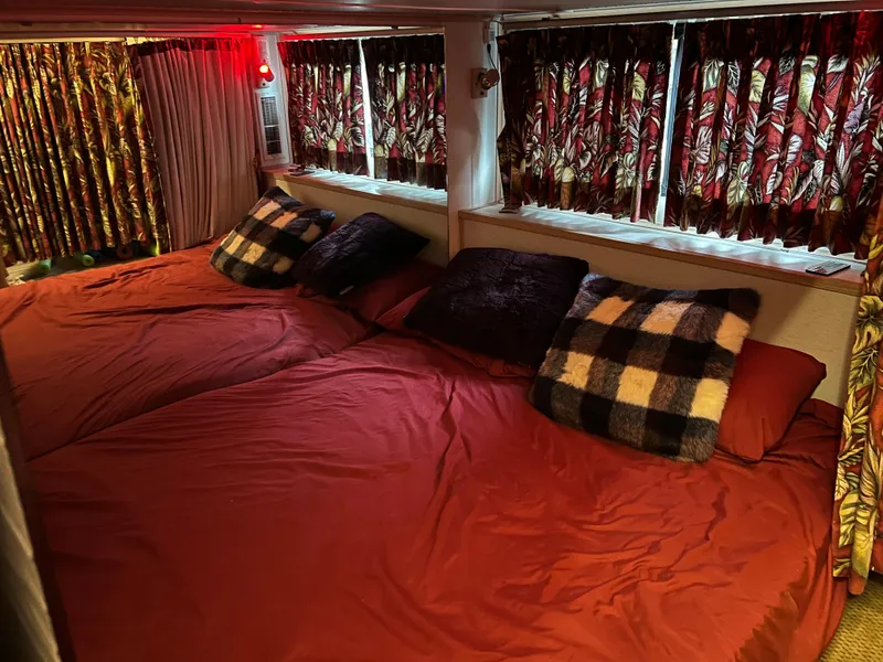 Slide: The Image of Cozy bedroom in 1996 Fun Country houseboat with red bedding and patterned curtains. - 20