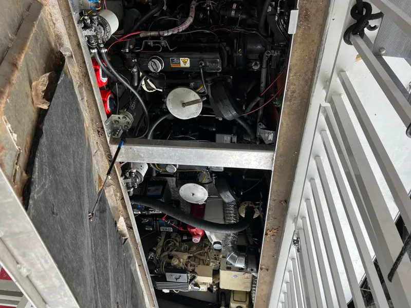 Slide: The Image of Engine compartment of a 1996 Fun Country 56 Forever 10 House Boat, showing mechanical components. - 29
