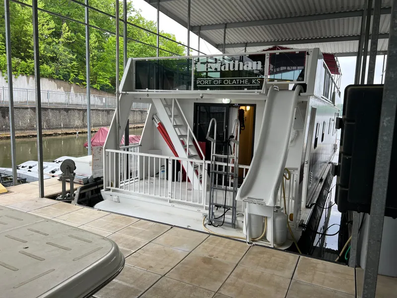 Slide: The Image of Houseboat docked in marina, Fun Country 56 Forever 10, 1996 model, with slide and greenery. - 4