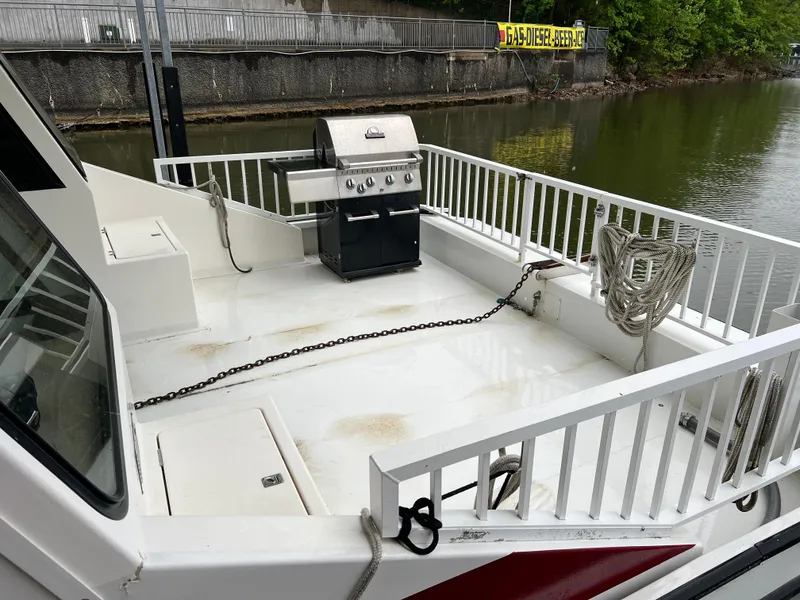 Slide: The Image of Houseboat deck with grill, ropes, and railing on a 1996 Fun Country 56 Forever 10 model. - 7