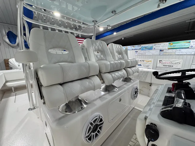 Slide: The Image of 2024 Contender 44 ST boat interior with luxurious white seating and modern controls. - 14