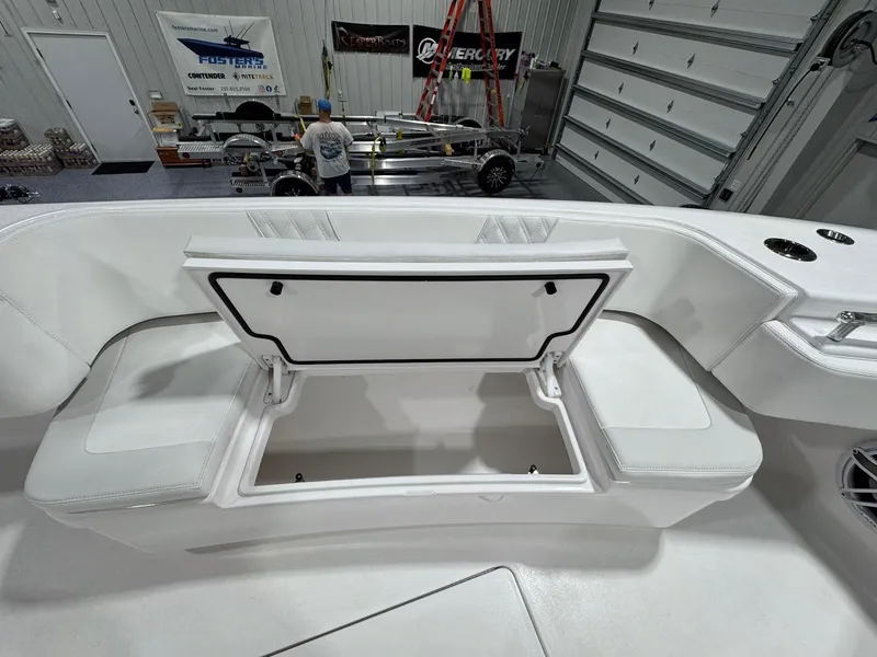 Slide: The Image of 2024 Contender 44 ST boat interior with open storage compartment in a showroom. - 29