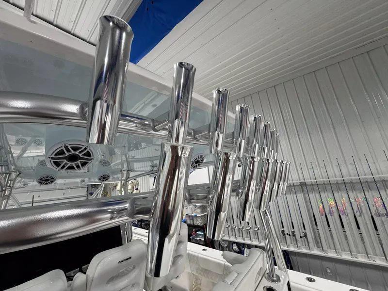 Slide: The Image of 2024 Contender 44 ST boat with polished rod holders and speakers in a sleek interior. - 39