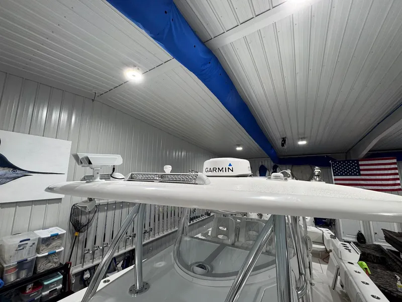 Slide: The Image of 2024 Contender 44 ST boat with Garmin equipment in a well-lit garage. - 40