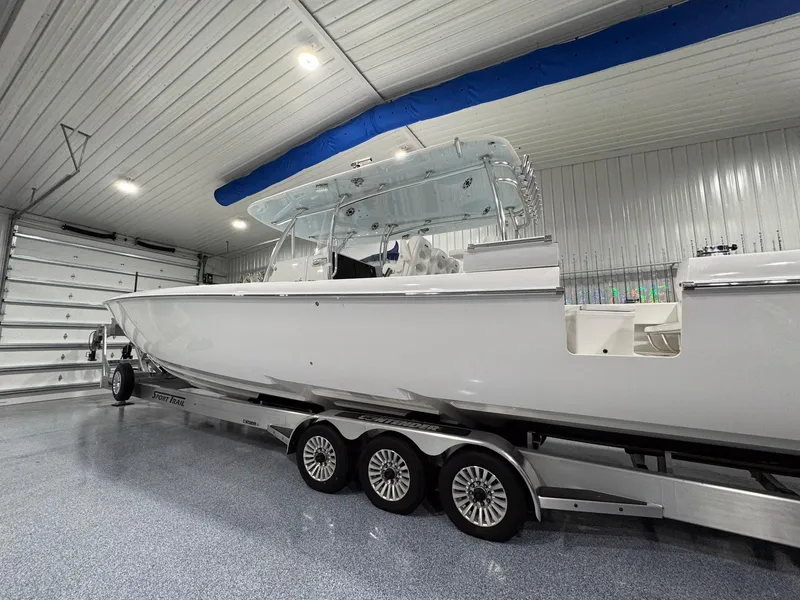 Slide: The Image of 2024 Contender 44 ST boat on trailer in a spacious indoor garage. - 42