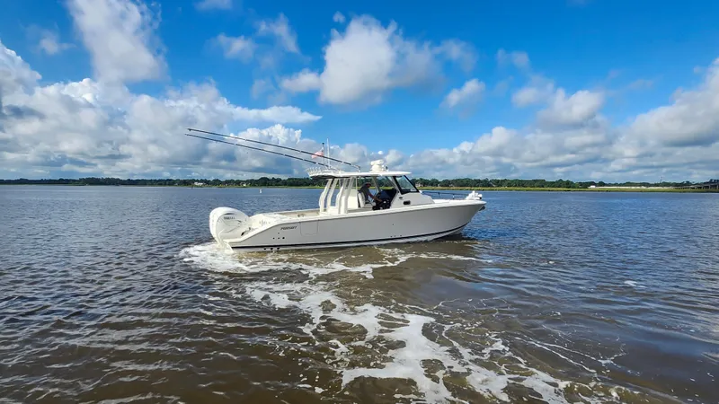 Slide: The Image of 2023 Pursuit S 358 Sport boat cruising on a sunny day with blue skies. - 14
