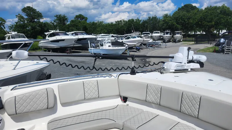 Slide: The Image of 2023 Pursuit S 358 Sport boat in marina, surrounded by other boats under a blue sky. - 17