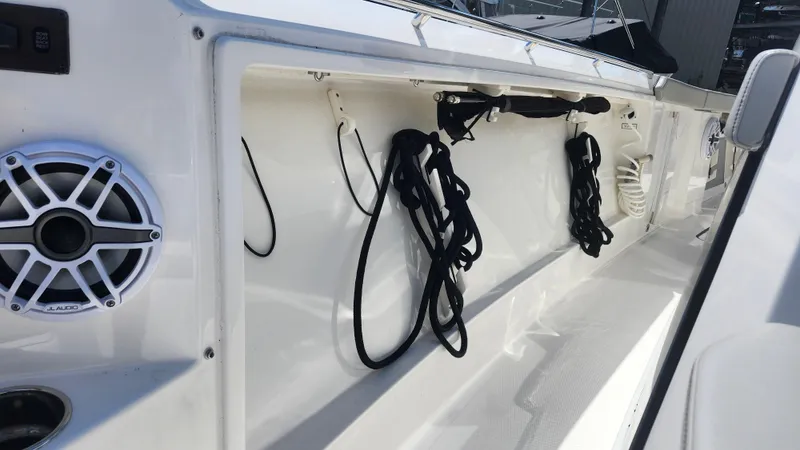 Slide: The Image of 2023 Pursuit S 358 Sport boat interior with speaker and storage compartment. - 24