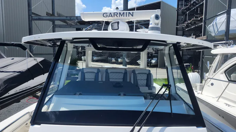 Slide: The Image of 2023 Pursuit S 358 Sport boat with Garmin equipment, docked in a marina. - 26