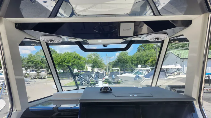 Slide: The Image of Interior view of 2023 Pursuit S 358 Sport boat with windshield and electronics. - 27