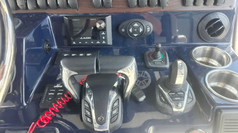 Slide: The Image of Control panel of 2023 Pursuit S 358 Sport boat with audio system and joystick controls. - 29