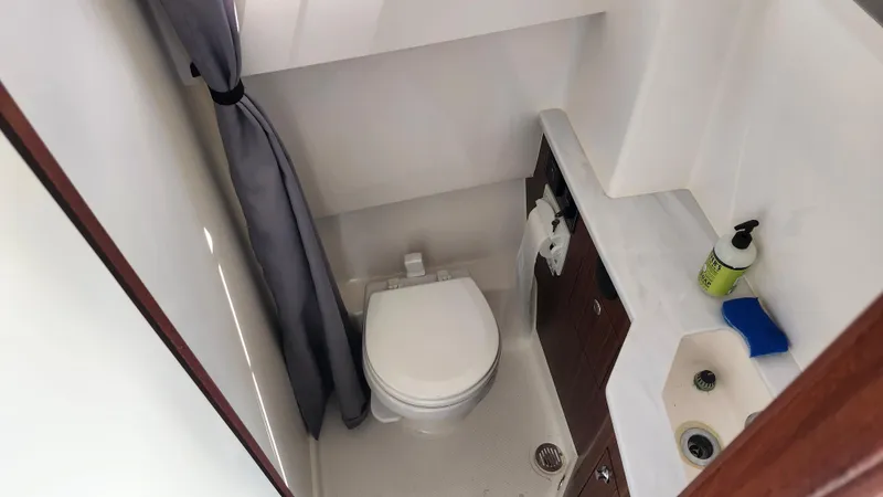 Slide: The Image of 2023 Pursuit S 358 Sport boat bathroom with toilet, sink, and storage. - 33