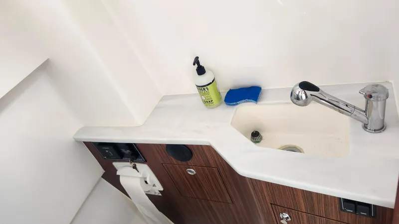 Slide: The Image of 2023 Pursuit S 358 Sport boat bathroom sink with faucet and soap. - 34