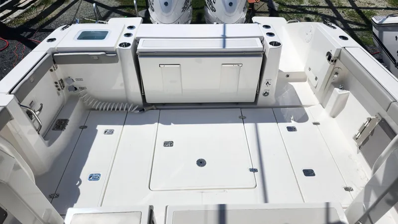 Slide: The Image of 2023 Pursuit S 358 Sport boat deck with storage compartments and seating area. - 37