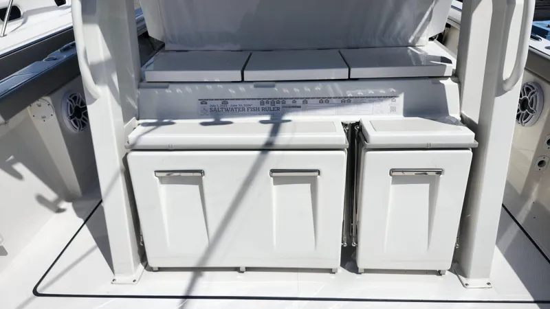 Slide: The Image of 2023 Pursuit S 358 Sport boat interior with storage compartments and fish ruler. - 41