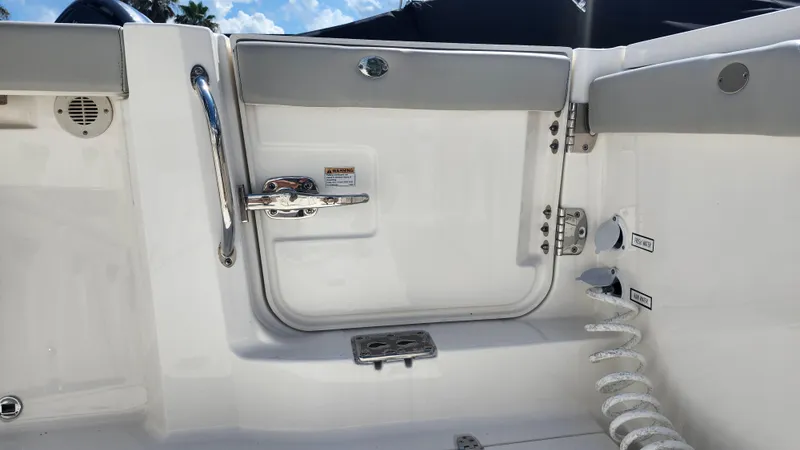 Slide: The Image of 2023 Pursuit S 358 Sport boat interior, featuring a sleek white door and chrome handle. - 44