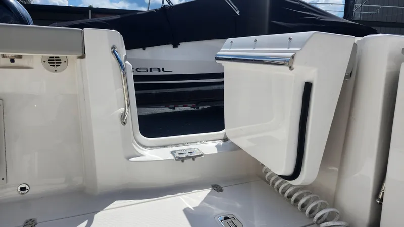 Slide: The Image of 2023 Pursuit S 358 Sport boat interior with open door and coiled rope. - 45